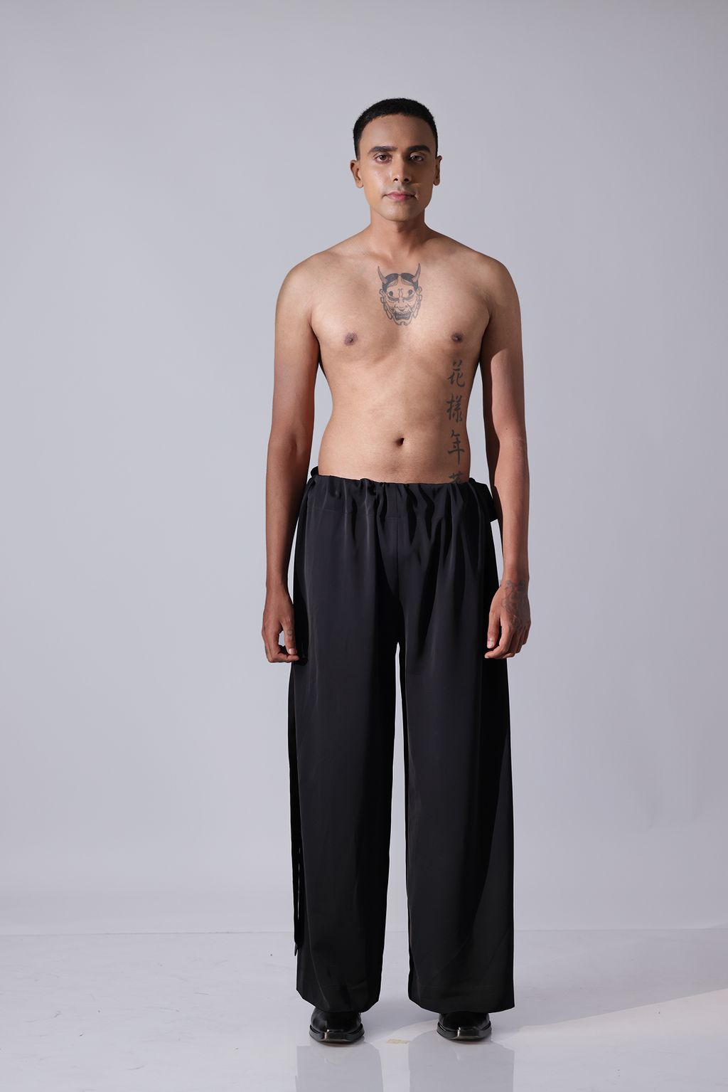 PANT - Black pants with broad flap detailing on botom hem