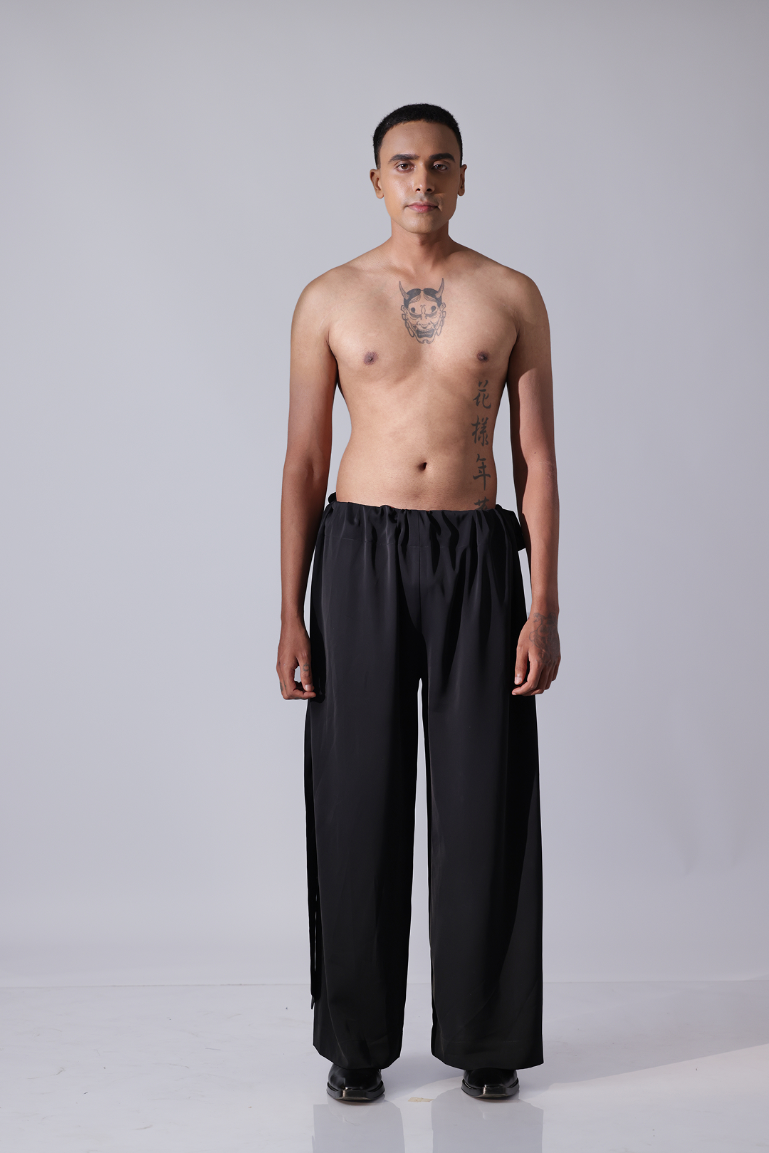 PANT - Black pants with broad flap detailing on botom hem
